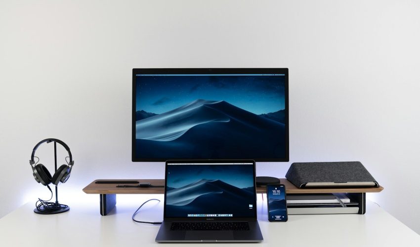 black laptop computer under black flat screen TV